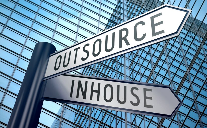 Crossroads sign with two arrows, office building - inhouse, outsource